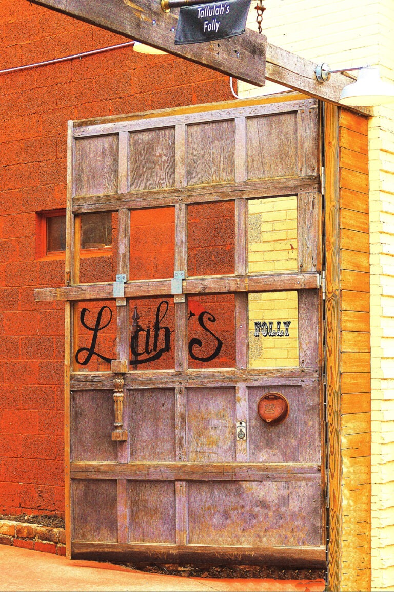 A rustic wooden door in a downtown urban neighborhood. Free download.
