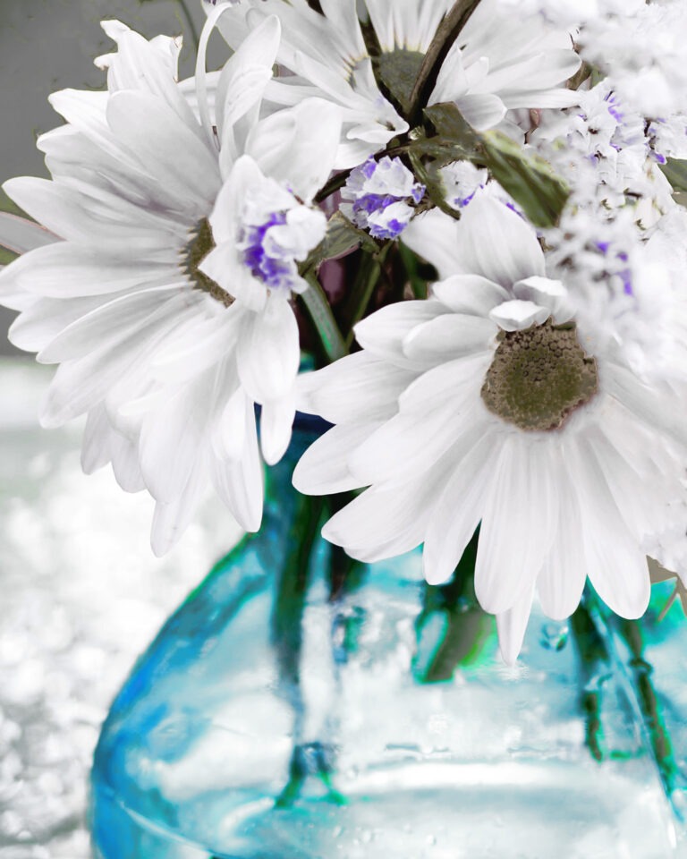 White daisies and small purple flowers in a translucent blue vase. Free download.